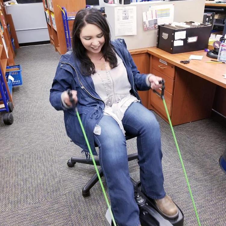 Employee exercising in their office using fitness equipment.