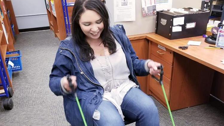 Employee exercising in their office using fitness equipment.