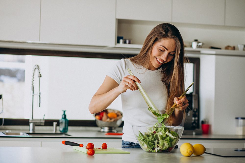 woman making a salad in her kitchen